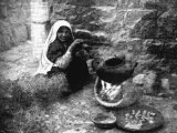 In the southern desert of Palestine a favourite food is red lentil soup, boiled and long simmered in an iron pot over a fire of brambles and twigs gathered from the thorny shrubs which grow on the hillsides.  An early photograph.